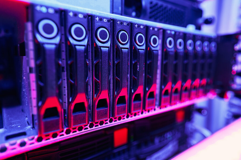 Close-up of illuminated rack-mounted computer hardware in a data center, showcasing advanced technology and high-performance computing
